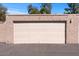 Single-car garage with a neutral-colored door and textured exterior, providing secure parking and additional storage space at 7312 N Via Camello Del Norte St # 95, Scottsdale, AZ 85258