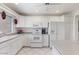Bright, all-white kitchen with tile floors, ample counter space, and modern appliances for a functional cooking experience at 7312 N Via Camello Del Norte St # 95, Scottsdale, AZ 85258