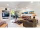 Open living room featuring tile floors, ceiling fan, media center and access to outdoor seating at 7312 N Via Camello Del Norte St # 95, Scottsdale, AZ 85258