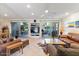 Spacious living room with tile flooring, ceiling fan, media center and outdoor access at 7312 N Via Camello Del Norte St # 95, Scottsdale, AZ 85258
