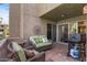 Cozy outdoor patio featuring comfortable seating, a gas grill, and an outdoor rug for relaxed outdoor living and entertaining at 7312 N Via Camello Del Norte St # 95, Scottsdale, AZ 85258