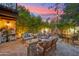 Cozy backyard patio with a gas fire pit, comfortable seating, and bamboo privacy screen at 8001 N 3Rd Pl, Phoenix, AZ 85020