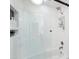 A bright bathroom featuring herringbone tile, glass shower doors, and modern fixtures at 8001 N 3Rd Pl, Phoenix, AZ 85020