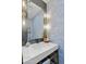 Chic bathroom with modern fixtures, stylish mirror, and patterned wallpaper, creating a sophisticated space at 8001 N 3Rd Pl, Phoenix, AZ 85020