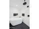 A modern bathroom with a standalone tub, sleek fixtures, and stylish herringbone and honeycomb tile work at 8001 N 3Rd Pl, Phoenix, AZ 85020