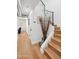 Hallway with wood floors leading to wooden staircase and adjacent sitting area at 8001 N 3Rd Pl, Phoenix, AZ 85020
