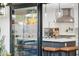View into a modern kitchen featuring white cabinets, an island with seating, and stainless steel appliances at 8001 N 3Rd Pl, Phoenix, AZ 85020