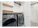 A modern laundry room features a washer and dryer, with decorative tile floors and built-in storage at 8001 N 3Rd Pl, Phoenix, AZ 85020