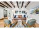 Open living area with wood beam ceilings, comfortable seating, and bright, natural light at 8001 N 3Rd Pl, Phoenix, AZ 85020
