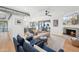 Stylish living room featuring a fireplace, modern furnishings, hardwood floors, and an open layout to the kitchen at 8001 N 3Rd Pl, Phoenix, AZ 85020