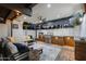 Well-equipped outdoor kitchen with a built-in grill, countertop space, ceiling fan, and comfortable seating area at 8001 N 3Rd Pl, Phoenix, AZ 85020