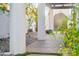 A serene walkway surrounded by lush greenery, featuring white pillars and stone accents at 8001 N 3Rd Pl, Phoenix, AZ 85020