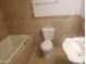 Bathroom features a bathtub, toilet and sink at 8141 W Elm St, Phoenix, AZ 85033