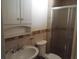 Bathroom with tiled shower and white sink at 8141 W Elm St, Phoenix, AZ 85033