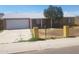 Traditional home with a well-kept lawn, a two-car garage, and a cozy front porch at 8141 W Elm St, Phoenix, AZ 85033