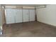 Spacious garage with a white sectional door offering ample storage and parking at 8141 W Elm St, Phoenix, AZ 85033
