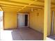 Covered yellow patio and entrance to house at 8141 W Elm St, Phoenix, AZ 85033