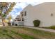 View of an inviting two-story home showcasing its well-manicured lawn with shrubs, a green lawn and a sidewalk at 850 S River Dr # 1112, Tempe, AZ 85281