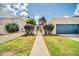 Beige home with a two-car garage and gated entryway with desert landscaping at 905 E Marco Polo Rd, Phoenix, AZ 85024