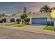 Beige home with a two-car garage, gated entryway and desert landscaping at 905 E Marco Polo Rd, Phoenix, AZ 85024