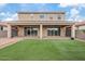 Expansive backyard featuring a covered patio, lush artificial turf, and seamless indoor-outdoor living at 9743 E Torino Ave, Mesa, AZ 85212