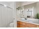 Bathroom offers a vanity with wood cabinets, a large mirror, and a shower-tub combination at 9743 E Torino Ave, Mesa, AZ 85212