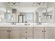 Elegant bathroom with dual vanity, sleek hardware, expansive mirror, and modern fixtures at 9743 E Torino Ave, Mesa, AZ 85212