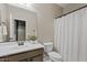 Bathroom with a single vanity, faucet, shower curtain, and toilet at 9743 E Torino Ave, Mesa, AZ 85212
