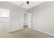This bedroom offers neutral walls, carpet flooring, ceiling fan and a walk-in closet at 9743 E Torino Ave, Mesa, AZ 85212