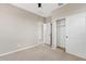 Neutral bedroom with ceiling fan, door, and closet at 9743 E Torino Ave, Mesa, AZ 85212