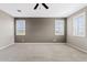 A spacious bedroom with large windows and neutral carpet at 9743 E Torino Ave, Mesa, AZ 85212