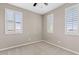 This bedroom offers neutral walls, carpet flooring and three windows with white shutters at 9743 E Torino Ave, Mesa, AZ 85212