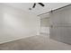 Bedroom with neutral carpet and a gray sliding barn door to the next room at 9743 E Torino Ave, Mesa, AZ 85212