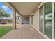 Covered patio features brick pavers, ceiling fan, wood slat wall and desert landscaping at 9743 E Torino Ave, Mesa, AZ 85212