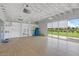 Well-lit exercise room with open floor plan, storage shelves, and sliding glass doors at 9743 E Torino Ave, Mesa, AZ 85212