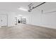 A spacious garage with ample room for multiple vehicles and storage shelves on the back wall at 9743 E Torino Ave, Mesa, AZ 85212