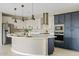 Bright kitchen boasts white cabinets, stainless steel appliances, and a large island perfect for entertaining at 9743 E Torino Ave, Mesa, AZ 85212