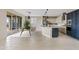 Open-concept kitchen with large island, modern appliances, and dining area with access to the backyard at 9743 E Torino Ave, Mesa, AZ 85212
