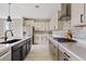 A spacious modern kitchen with stainless steel appliances, light countertops and tile backsplash at 9743 E Torino Ave, Mesa, AZ 85212