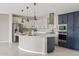 This kitchen features stainless steel appliances, pendant lighting, and a large island with bar seating at 9743 E Torino Ave, Mesa, AZ 85212