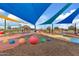 Fun playground featuring vibrant colors, unique structures, and shaded areas for to enjoy at 9743 E Torino Ave, Mesa, AZ 85212