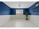 Stylish room featuring blue accent wall, white wainscoting, and bright natural light through the shuttered window at 9743 E Torino Ave, Mesa, AZ 85212