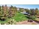 A beautiful aerial view of a community park with lush greenery, a basketball court, and mature trees at 10928 W Kaler Dr, Glendale, AZ 85307