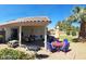 Charming covered back patio featuring an outdoor dining table and BBQ, perfect for entertaining guests at 10928 W Kaler Dr, Glendale, AZ 85307