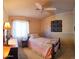 Bedroom featuring a single bed, wooden floors, and bright window at 10928 W Kaler Dr, Glendale, AZ 85307