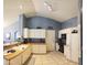 Efficient kitchen layout with white cabinets, modern appliances, and views into the dining area at 10928 W Kaler Dr, Glendale, AZ 85307