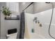 Bathroom featuring a white shower/tub combination with a tiled surround and a plant by the window at 1225 N 36Th St # 2101, Phoenix, AZ 85008