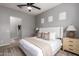 Neutral-toned bedroom featuring a ceiling fan, an upholstered bed, and natural light from the window at 1225 N 36Th St # 2101, Phoenix, AZ 85008