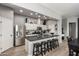 Well-lit kitchen with a center island, barstool seating, stainless steel appliances, and modern cabinetry at 1225 N 36Th St # 2101, Phoenix, AZ 85008