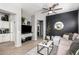 Modern living room featuring sleek wood flooring, comfortable seating, and a stylish accent wall with decor at 1225 N 36Th St # 2101, Phoenix, AZ 85008